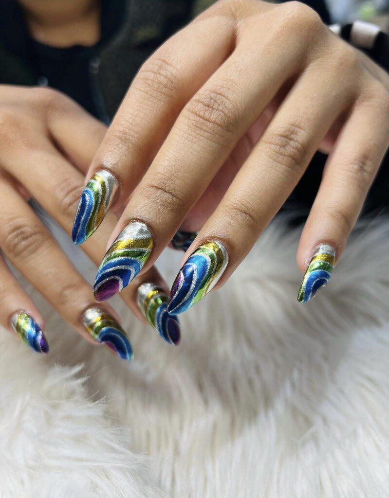 Blue, green, gold, and silver swirl nails