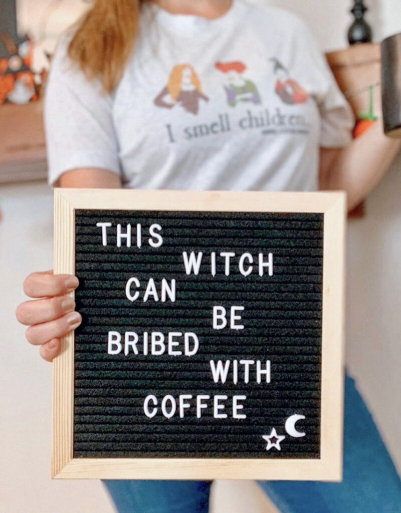 girl holding letterboard with halloween quote