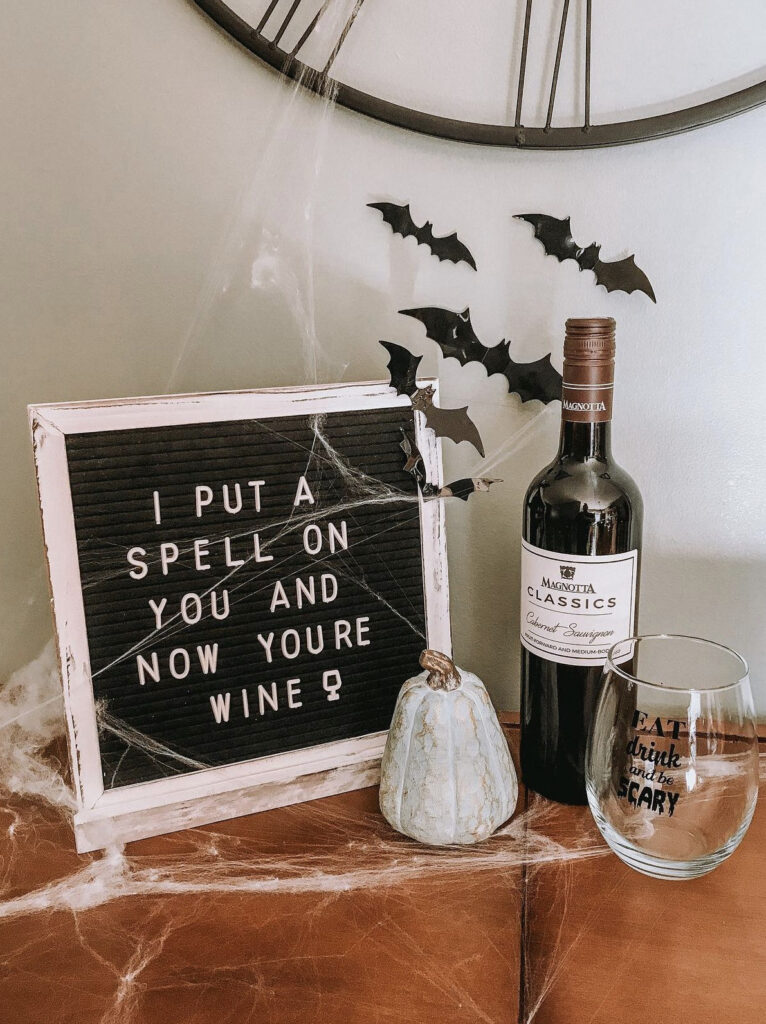 letterboard with halloween quote and wine