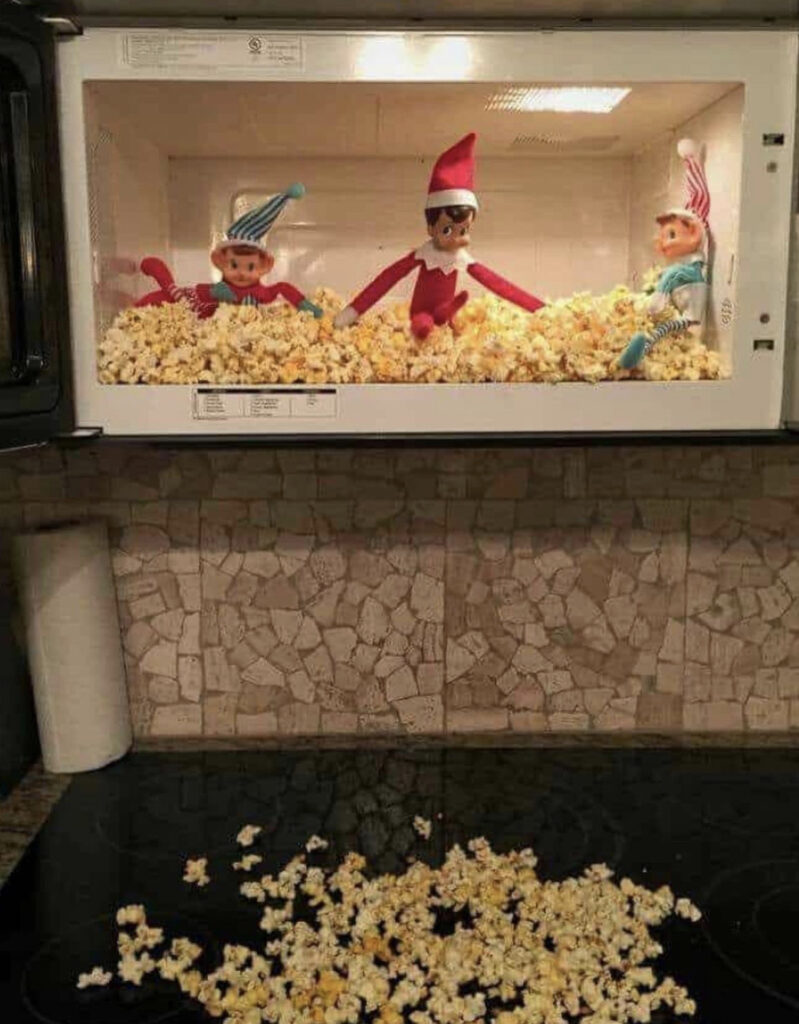 Elves making a mess of popcorn in the microwave