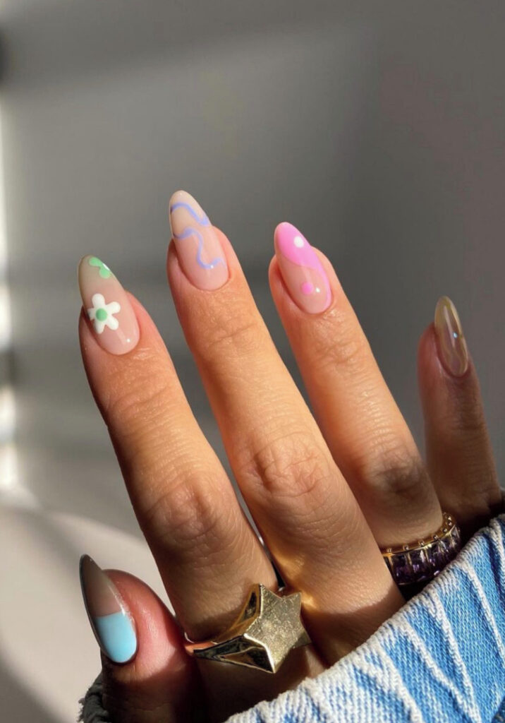 Yin & yang, daisies, and squiggles pastel nail art on nude nails