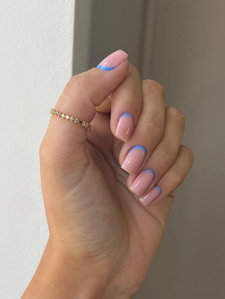 Subtle pastel violet designs on nude pink nails